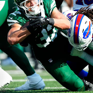 New York Jets running back Isaiah Davis (32) is tackled by Buffalo Bills defensive tackle T.J. Sanders (98), Sunday, September 14, 2025, in East Rutherford.