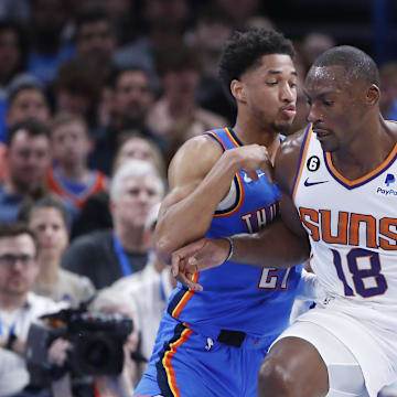 Apr 2, 2023; Oklahoma City, Oklahoma, USA; Phoenix Suns center Bismack Biyombo (18) drives against Oklahoma City Thunder guard Aaron Wiggins (21) during the second quarter at Paycom Center. Mandatory Credit: Alonzo Adams-Imagn Images
