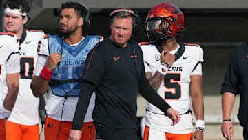 Oct 26, 2024; Berkeley, California, USA; Oregon State Beavers head coach Trent Bray (center) walks on the sideline in front of quarterbacks Dom Montiel (center left) and Gabarri Johnson (5) during the fourth quarter against the California Golden Bears at California Memorial Stadium. Mandatory Credit: Darren Yamashita-Imagn Images