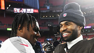 Cleveland Browns quarterback Shedeur Sanders shakes hands with Tennessee Titans quarterback Cam Ward.