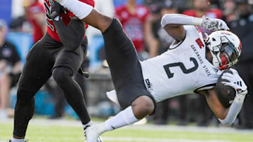 Northern Illinois Huskies safety Muhammed Jammeh (21) stops Arkansas State Red Wolves running back Ja'Quez Cross (2) in second half action in the Camellia Bowl at Cramton Bowl in Montgomery, Ala., on Saturday December 23, 2023.