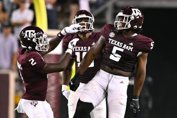 Texas A&M Aggies defensive back Jacoby Mathews, defensive lineman Fadil Diggs and defensive lineman Shemar Turner celebrate.