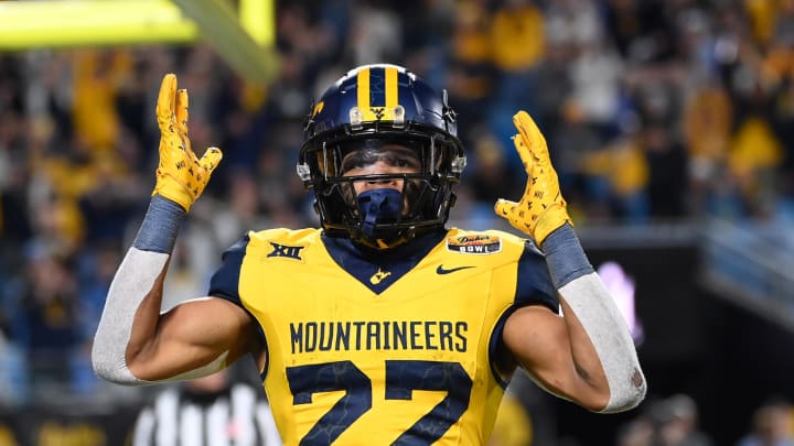 Dec 27, 2023; Charlotte, NC, USA; West Virginia Mountaineers running back Jahiem White (22) reacts after scoring a touchdown in the fourth quarter at Bank of America Stadium. Mandatory Credit: Bob Donnan-USA TODAY Sports