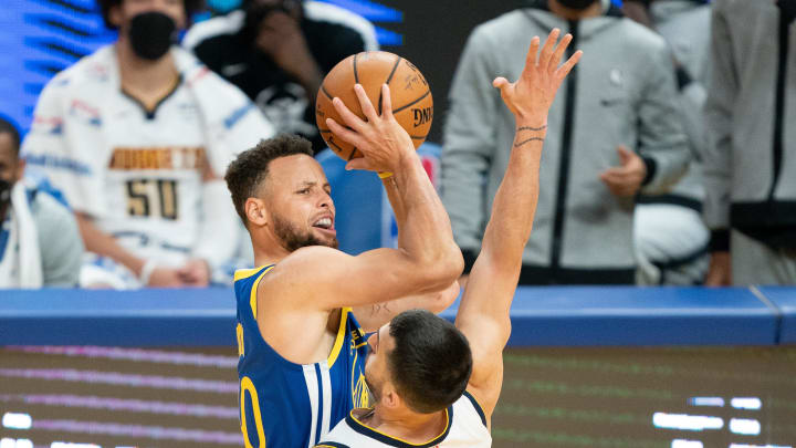 Golden State Warriors guard Stephen Curry (30) shoots the basketball against Denver Nuggets guard Facundo Campazzo (7) during the fourth quarter at Chase Center. Mandatory Credit: