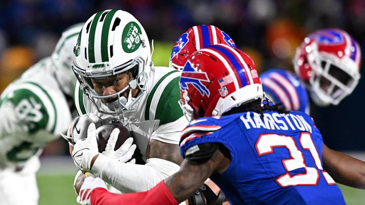 Jan 4, 2026; Orchard Park, New York, USA; New York Jets wide receiver John Metchie III (3) carries the ball defended by Buffalo Bills cornerback Maxwell Hairston (31) during the fourth quarter at Highmark Stadium. Mandatory Credit: Mark Konezny-Imagn Images