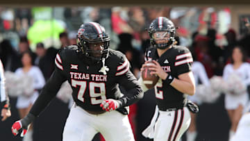 Nov 30, 2024; Lubbock, Texas, USA;  Texas Tech Red Raiders offensive guard Sterling Porcher (79) blocks for quarterback Behren Morton (2) in the second half during the game against the West Virginia Mountaineers at Jones AT&T Stadium and Cody Campbell Field. Mandatory Credit: Michael C. Johnson-Imagn Images