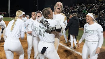A jubilant Oregon squad celebrates after their 10-7 comeback win over Stanford Sunday at Jane Sanders Stadium. Oregon wrested a pair from the The Cardinal to earn a host berth in Super Regional round of the NCAA Softball Tournament.