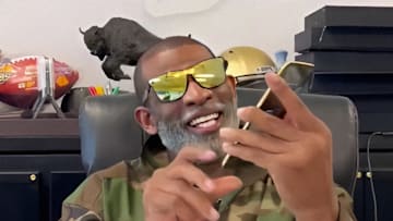 Deion Sanders with Boost Mobile Razr 