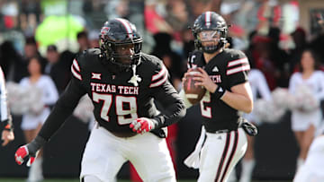 Nov 30, 2024; Lubbock, Texas, USA;  Texas Tech Red Raiders offensive guard Sterling Porcher (79) blocks for quarterback Behren Morton (2) in the second half during the game against the West Virginia Mountaineers at Jones AT&T Stadium and Cody Campbell Field. Mandatory Credit: Michael C. Johnson-Imagn Images
