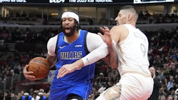 Mar 29, 2025; Chicago, Illinois, USA; Chicago Bulls center Nikola Vucevic (9) defends Dallas Mavericks forward Anthony Davis (3) during the second half at United Center. Mandatory Credit: David Banks-Imagn Images