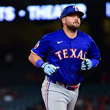 Jul 8, 2025; Anaheim, California, USA; Texas Rangers first baseman Jake Burger (21) runs the bases after hitting a solo home run against the Los Angeles Angels during the seventh inning at Angel Stadium. 