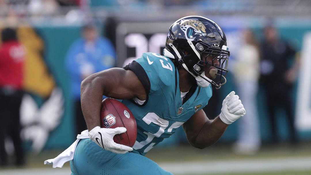 Dec 14, 2025; Jacksonville, Florida, USA; Jacksonville Jaguars running back Bhayshul Tuten (33) returns a kick during the third quarter against the New York Jets at EverBank Stadium. Mandatory Credit: Travis Register-Imagn Images