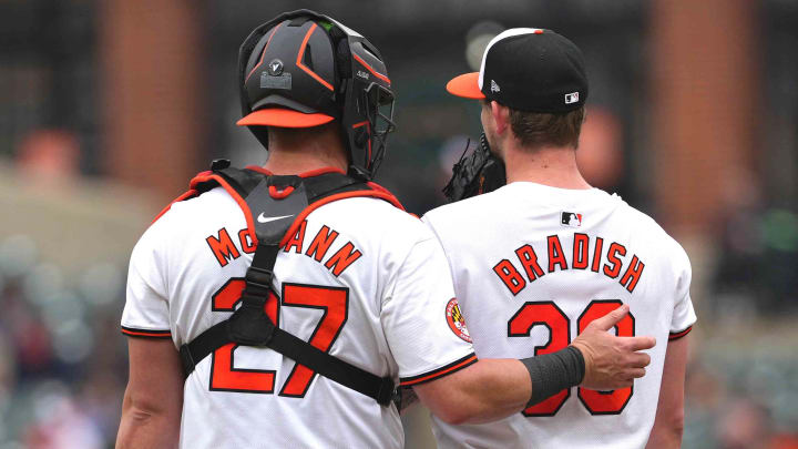 May 15, 2024; Baltimore, Maryland, USA; Baltimore Orioles pitcher Kyle Bradish (38) is visited by catcher James McCann (27) in the third inning against the Toronto Blue Jays at Oriole Park at Camden Yards