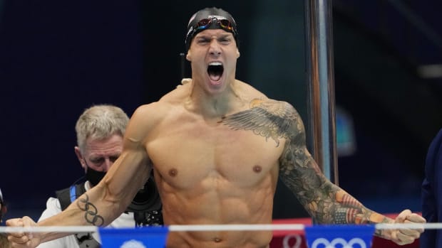 Caeleb Dressel celebrates after his relay team finishes first in a Tokyo Olympics event.