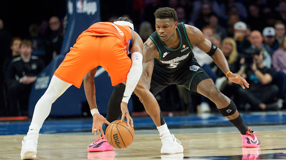 Minnesota Timberwolves guard Anthony Edwards defends Oklahoma City Thunder guard Shai Gilgeous-Alexander.