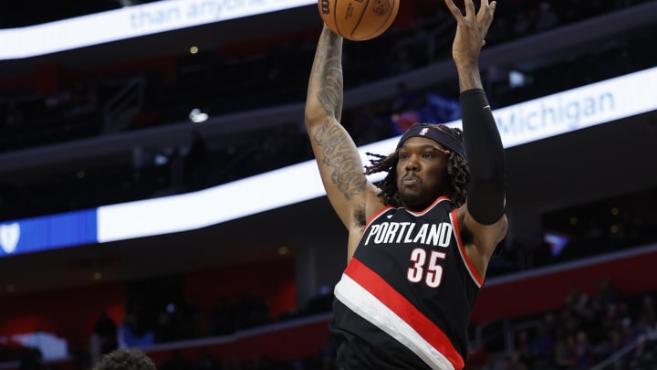 Nov 1, 2023; Detroit, Michigan, USA;  Portland Trail Blazers center Robert Williams III (35) grabs the rebound over Detroit Pistons guard Killian Hayes (7) in the first half at Little Caesars Arena.