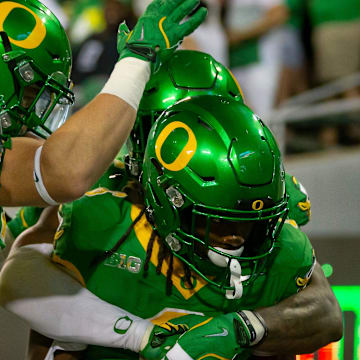 Oregon running back Noah Whittington celebrates a touchdown