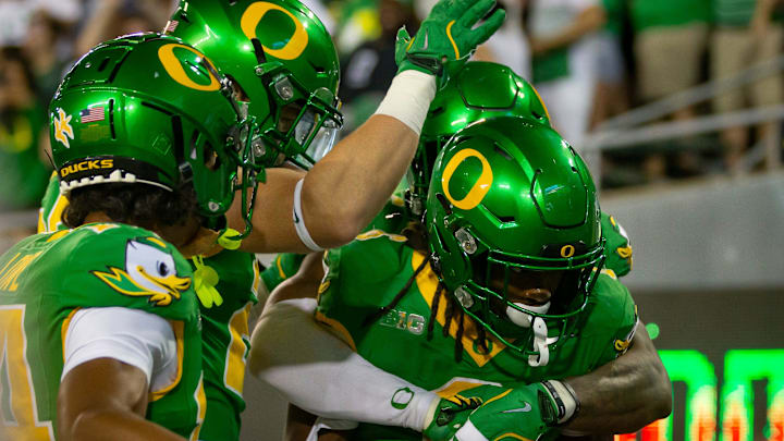 Oregon running back Noah Whittington celebrates a touchdown