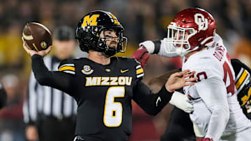 Nov 9, 2024; Columbia, Missouri, USA; Missouri Tigers quarterback Drew Pyne (6) throws a pass against Oklahoma Sooners defensive lineman Ethan Downs (40) during the second half at Faurot Field at Memorial Stadium. 