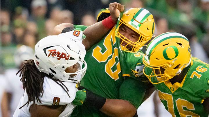 Oregon offensive linemen Nishad Strother, center, and Josh Conerly Jr., right, engage Maryland defensive lineman Jordan Phillips as the Oregon Ducks host the Maryland Terrapins at Autzen Stadium Saturday, Nov. 9, 2024 in Eugene, Ore.