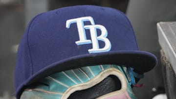 Sep 26, 2025; Toronto, Ontario, CAN; The hat and glove of Tampa Bay Rays third baseman Junior Caminero (13) in the dugout during the game against the Toronto Blue Jays at Rogers Centre. 