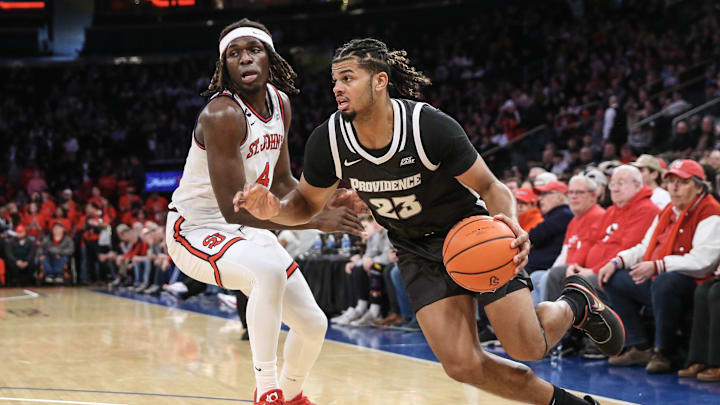 Feb 11, 2023; Queens, New York, USA;  Providence Friars forward Bryce Hopkins (23) looks to drive past St. John's basketball forward O'Mar Stanley (4) in the first half at Madison Square Garden.