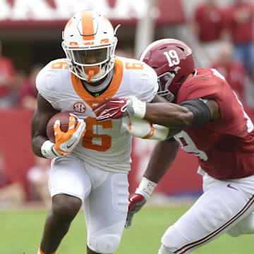 Oct 24, 2015; Tuscaloosa, AL, USA; Tennessee Volunteers running back Alvin Kamara (6) carries the ball against Alabama Crimson Tide linebacker Reggie Ragland (19) during the first quarter at Bryant-Denny Stadium. Mandatory Credit: John David Mercer-Imagn Images
