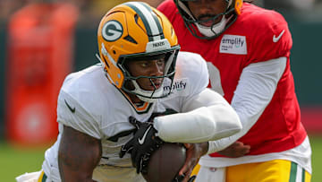 Green Bay Packers running back MarShawn Lloyd (32) takes a handoff in a drill during practice on Tuesday, August 12, 2025, at Ray Nitschke Field in Ashwaubenon, Wis. 