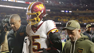 Nov 2, 2025; Landover, Maryland, USA; Washington Commanders quarterback Jayden Daniels (5) is helped off the field after an injury during the second half against the Seattle Seahawks at Northwest Stadium. Mandatory Credit: Amber Searls-Imagn Images