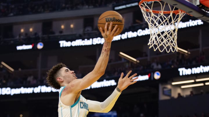 Dec 27, 2022; San Francisco, California, USA; Charlotte Hornets guard LaMelo Ball (1) lays the ball up over Golden State Warriors forward Draymond Green (23) during the first quarter at Chase Center. Mandatory Credit: D. Ross Cameron-USA TODAY Sports