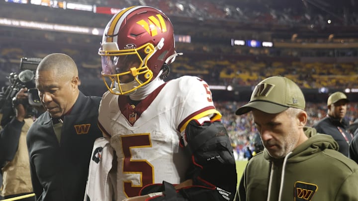 Nov 2, 2025; Landover, Maryland, USA; Washington Commanders quarterback Jayden Daniels (5) is helped off the field after an injury during the second half against the Seattle Seahawks at Northwest Stadium. Mandatory Credit: Amber Searls-Imagn Images