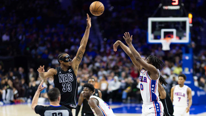 Apr 14, 2024; Philadelphia, Pennsylvania, USA; Philadelphia 76ers guard Tyrese Maxey (0) shoots over Brooklyn Nets center Nic Claxton (33) during the second quarter at Wells Fargo Center. Mandatory Credit: Bill Streicher-USA TODAY Sports