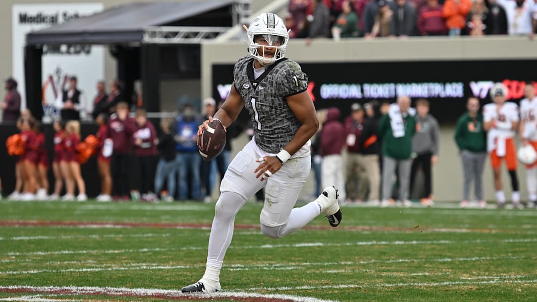 Nov 22, 2025; Blacksburg, Virginia, USA; Virginia Tech Hokies quarterback Kyron Drones (1) looks to pass against the Miami (FL) Hurricanes during the first quarter at Lane Stadium. Mandatory Credit: Brian Bishop-Imagn Images