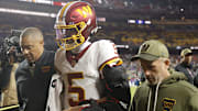Nov 2, 2025; Landover, Maryland, USA; Washington Commanders quarterback Jayden Daniels (5) is helped off the field after an injury during the second half against the Seattle Seahawks at Northwest Stadium. 