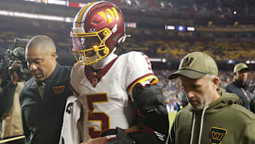 Nov 2, 2025; Landover, Maryland, USA; Washington Commanders quarterback Jayden Daniels (5) is helped off the field after an injury during the second half against the Seattle Seahawks at Northwest Stadium. 