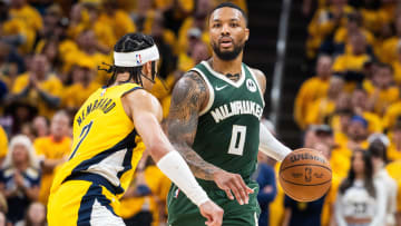 Apr 26, 2024; Indianapolis, Indiana, USA; Milwaukee Bucks guard Damian Lillard (0) dribbles the ball while Indiana Pacers guard Andrew Nembhard (2) defends during game three of the first round for the 2024 NBA playoffs at Gainbridge Fieldhouse. Mandatory Credit: Trevor Ruszkowski-USA TODAY Sports