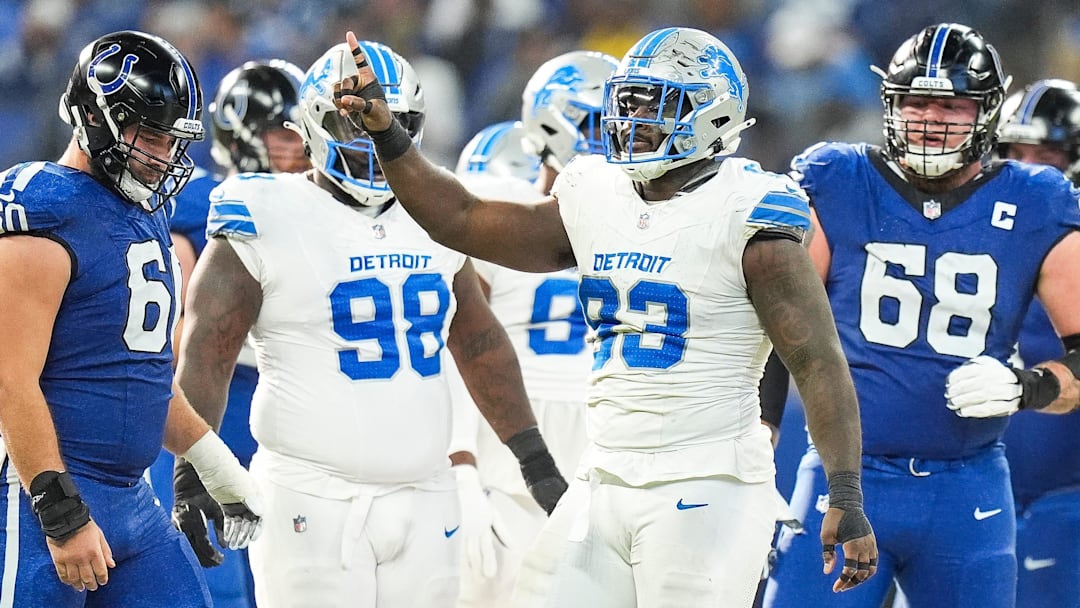 Detroit Lions defensive end Josh Paschal (93) celebrates a tackle against Indianapolis Colts running back Jonathan Taylor (28) during the first half at Lucas Oil Stadium in Indianapolis, Ind. on Sunday, Nov. 24, 2024.