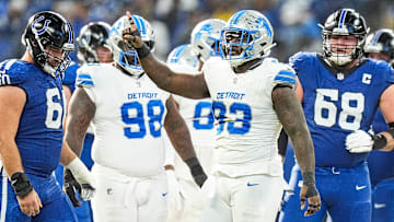 Detroit Lions defensive end Josh Paschal (93) celebrates a tackle against Indianapolis Colts running back Jonathan Taylor (28) during the first half at Lucas Oil Stadium in Indianapolis, Ind. on Sunday, Nov. 24, 2024.