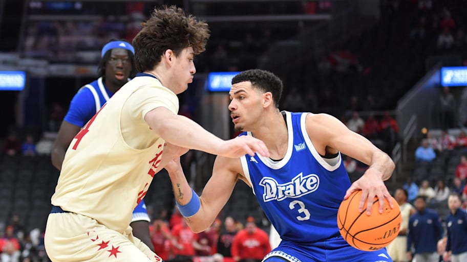 Drake guard Jalin Quinn drives the ball against UIC guard Andy Johnson in the semifinal game.
