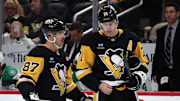 Nov 11, 2024; Pittsburgh, Pennsylvania, USA;  Pittsburgh Penguins center Sidney Crosby (87) and center Evgeni Malkin (71) react on the ice against the Dallas Stars during the third period at PPG Paints Arena. Mandatory Credit: Charles LeClaire-Imagn Images