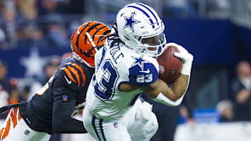 Dec 9, 2024; Arlington, Texas, USA; Dallas Cowboys running back Rico Dowdle (23) runs with the ball as Cincinnati Bengals cornerback DJ Ivey (38) defends during the first quarter at AT&T Stadium. Mandatory Credit: Kevin Jairaj-Imagn Images