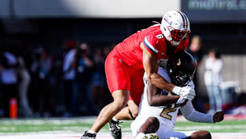 Oct 19, 2024; Tucson, Arizona, USA;  Arizona Wildcats linebacker Taye Brown (6) tackles Colorado Buffaloes quarterback Shedeur Sanders (2) during the third quarter at Arizona Stadium. Mandatory Credit: Aryanna Frank-Imagn Images