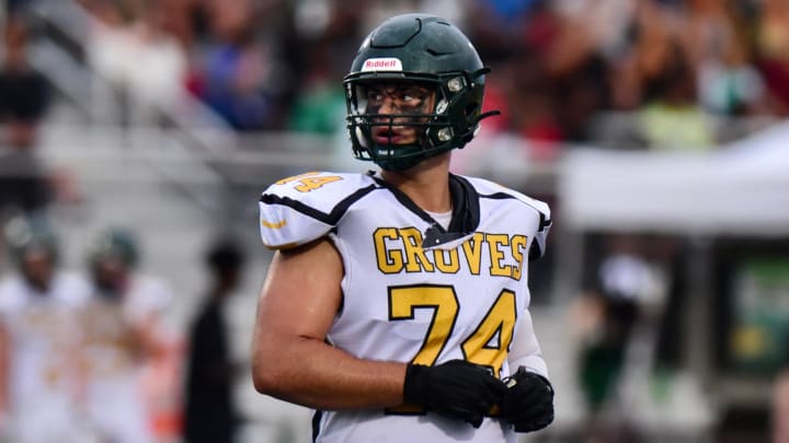 Birmingham Groves' Avery Gach takes the field for a series during an Oakland Activities Association crossover football game Friday, Aug. 25, 2023.