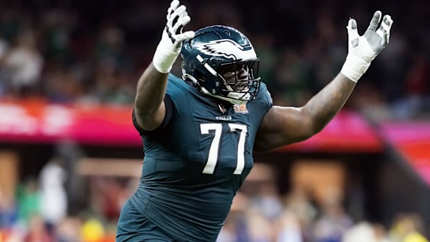 Eagles guard Mekhi Becton (green jersey) gives his opinion on a call made on the field.        