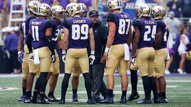 In 2018,  UW tight-ends coachJordan Paopao talks to his players during a game against North Dakota.