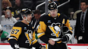 Nov 11, 2024; Pittsburgh, Pennsylvania, USA;  Pittsburgh Penguins center Sidney Crosby (87) and center Evgeni Malkin (71) react on the ice against the Dallas Stars during the third period at PPG Paints Arena.