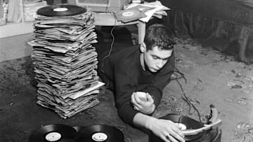DJ Dean Calagno with a stack of records, circa 1955
