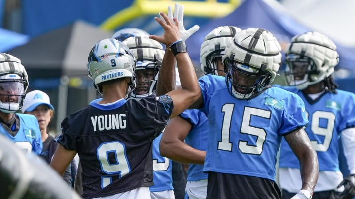 Jul 24, 2024; Charlotte, NC, USA; Carolina Panthers quarterback Bryce Young (9) high fives wide receiver Jonathan Mingo (15) at Carolina Panthers Practice Fields. Mandatory Credit: Jim Dedmon-USA TODAY Sports