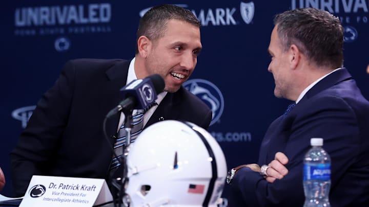 Dec 8, 2025; University Park, PA, USA; Matt Campbell, left, speaks with Penn State University athletic director Pat Kraft, right, while being announced as the Penn State Nittany Lions new head coach during a press conference at the Beaver Stadium Press Room. Mandatory Credit: Matthew O'Haren-Imagn Images