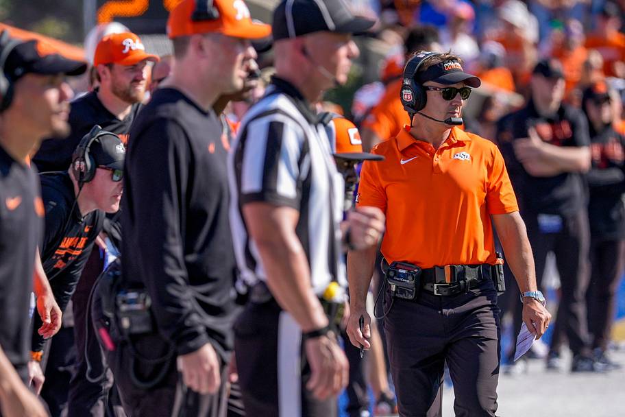 Oklahoma State head coach Eric Morris walks up the sideline.